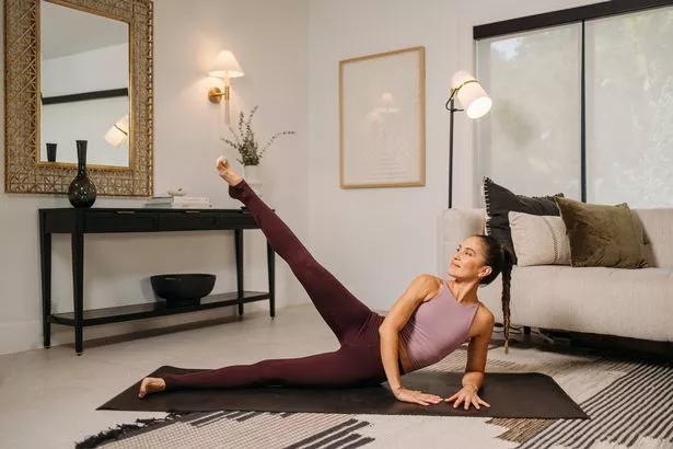 Woman doing yoga in her living room